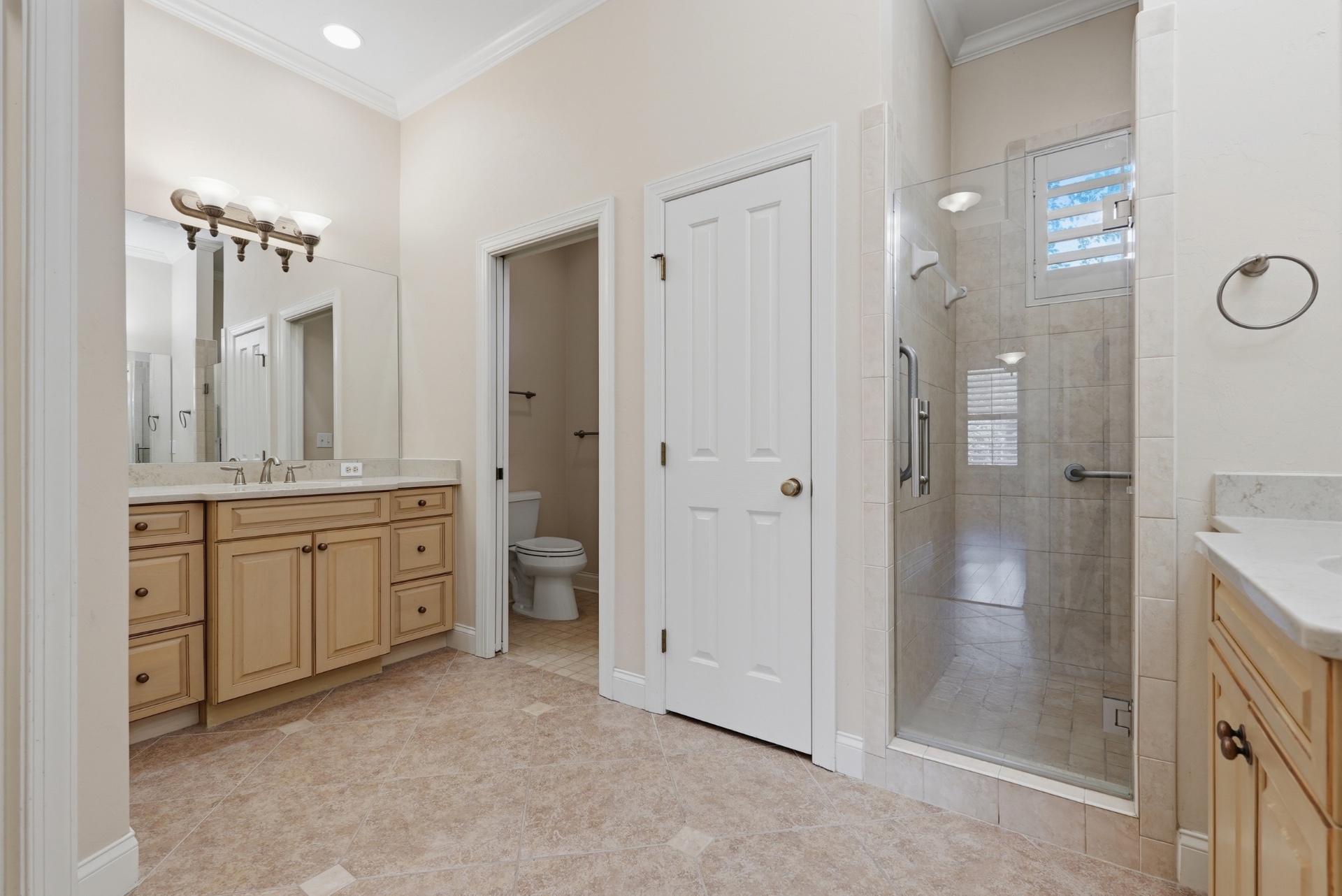 Primary bath with separate vanities, walk-in shower and water closet