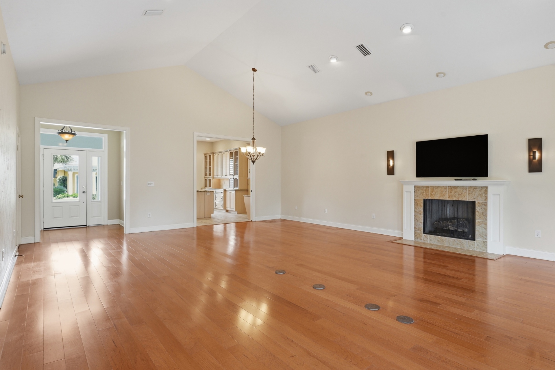 Vaulted great room with gas fireplace and engineered hardwood floors